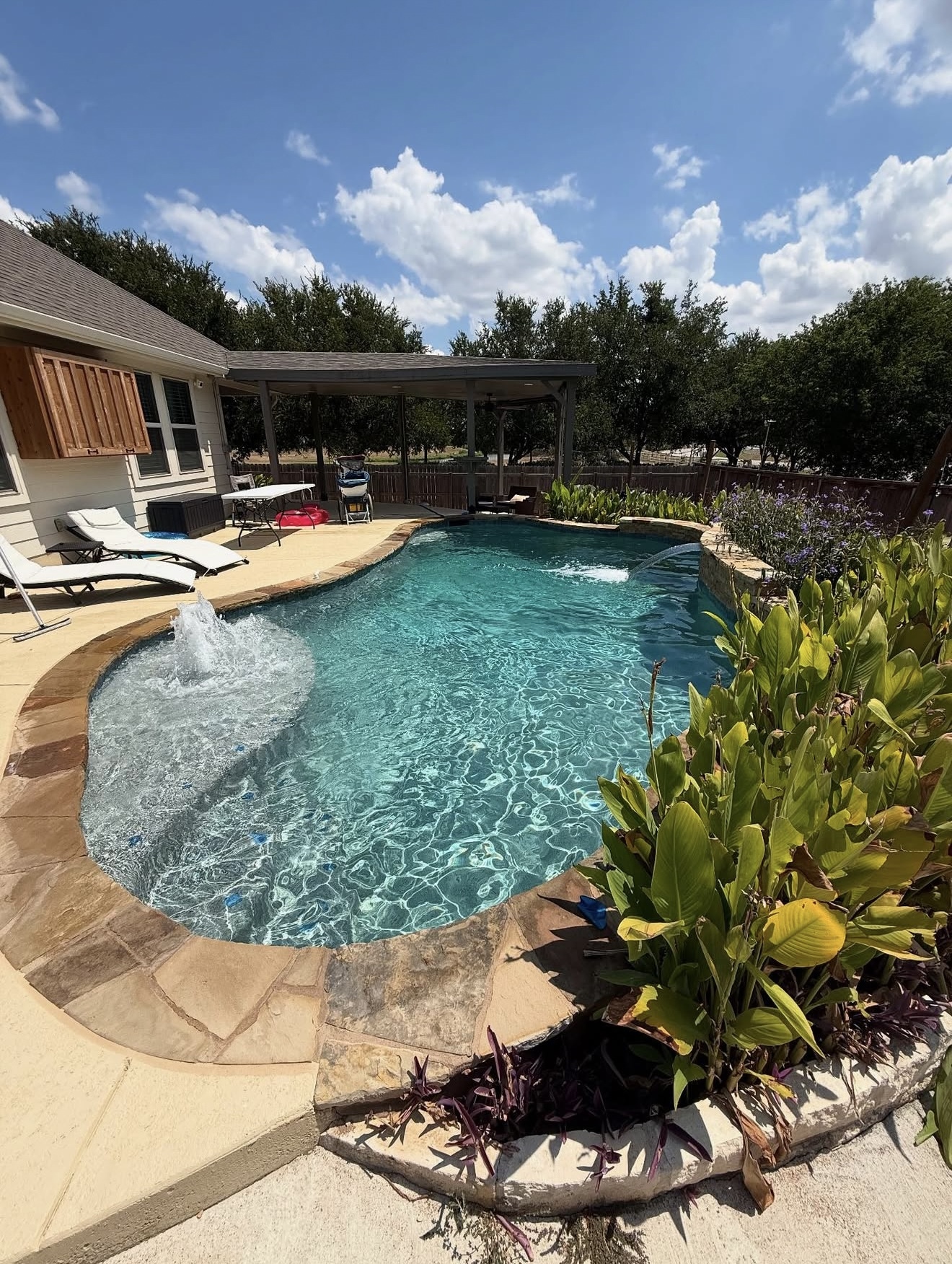 Pool with bubbler and waterfall feature after remodel